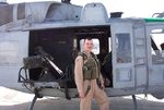 Posing with a Marine UH-1N Huey, check out the 50 cal, Camp Udarie, Kuwait - Feb. 21, 20042.JPG