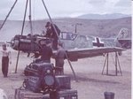 Ground_crew_work_on_the_engine_of_a_Bf_109E_at_the_Svretv_Vr.jpg